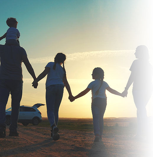 parents and fun children walk silhouette next to car