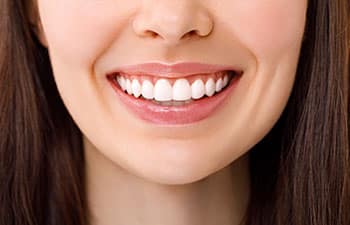 A beautiful woman is smiling. a smile with white teeth